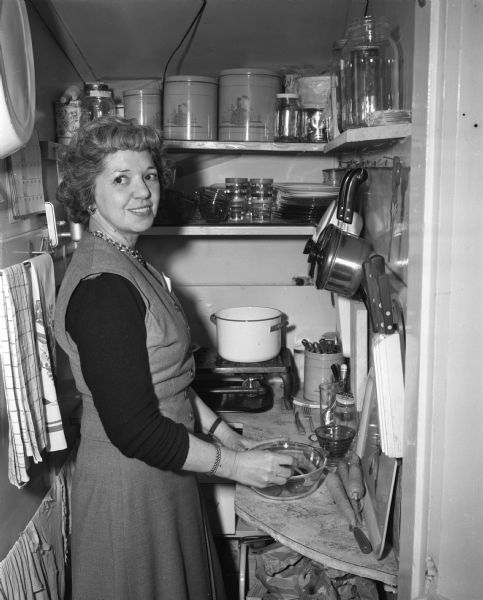 Louise Zieske in her kitchen demonstrating how to make her cheese-rice casserole, which was selected as best of 517 entries in the "Wisconsin State Journal's" first recipe contest.