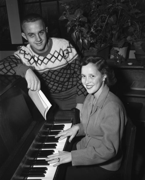 East High School students Beverly Sime, playing the piano, and Frank Hanson, rehearsing for the "Pirates of Penzance" operetta.
