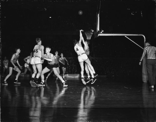 Forward Don Page (4) shoots over an Illinois player while Doug Rogers (46) is guarded at the left during the University of Wisconsin basketball game against Illinois at the University of Wisconsin-Madison Field House.