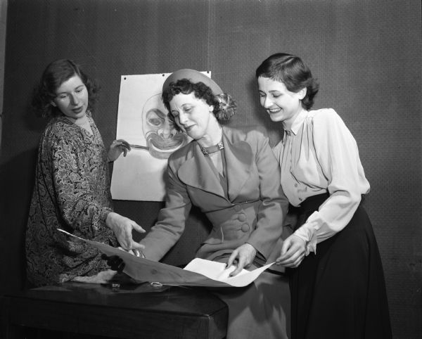 Committee members creating the guest program for "A Combine of Comedy" produced by Phi Beta. Left to right: Mrs. Gordon (Eleanor) Rowley, 904 Oakland Avenue, general chairman; Mrs. Stuart (Carol) Reid, 724 Blackhawk Avenue, retiring president of the alumnae group; and Rella Israly, Des Moines Iowa, president of the university chapter of Phi Beta.