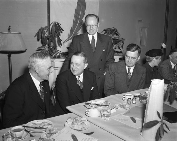 Attending the annual dinner of the Madison Community Chest are, left to right: Chief Justice Marvin Rosenberry, first president of the organization; Stanley C. Allyn, vice-president of the Community Chest; John E. Canfield (standing), past Madison campaign chairman; and E.L. Wingert, president.