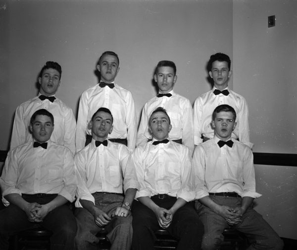 Popular singers in the city's young set are the eight boys who make up East High School's double quartet. First row, left to right: George Otis, Jim Bailey, Ken Herling and Don Hovde. Second row, left to right: Eugene Eldred, Frank Hanson, Bob Jensen and Jim Hubin. Taken for the "Youth Journal" section of the newspaper.