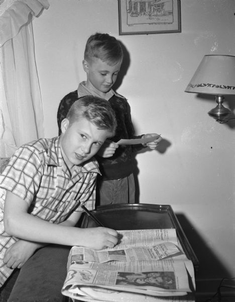 Joe Conrad 12, at left, and Jim Conrad 8, at right, sons of Mr. and Mrs. Edwin Conrad, 1225 Sweetbriar Road. Joe won first prize in the third "Wisconsin State Journal" "Know These Badgers" contest, and was also a winner in the first contest.