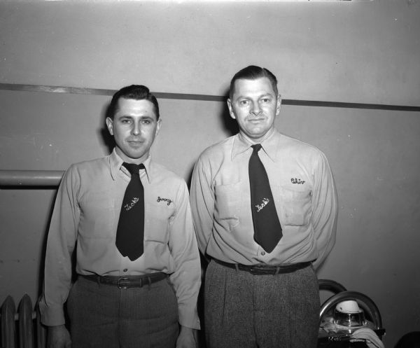 Group portrait of Jerry Grosse and Clarence Chivers, Madison's 1949 doubles champions, winners in the 44th annual men's city bowling tourament. The men are wearing embroidered neckties and embroidered shirts.