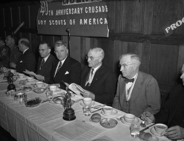 At the speakers' table at the 29th annual dinner of the Four Lakes Boy Scout council are left to right: H.C. Nicholls, council president; V.A. Raymond, scout commissioner and toastmaster; Chief Justice Marvin Rosenberry; and Wakelin McNeel, 'Ranger Mac,' State 4-H club director."
