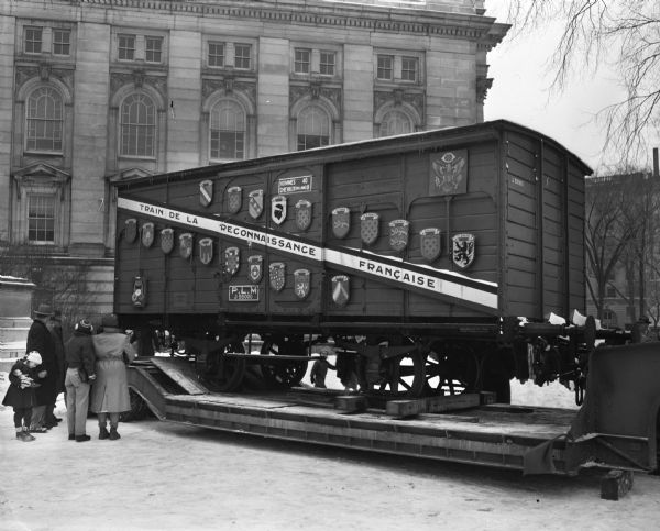 French Gratitude Train boxcar, (Merci Train) carrying gifts for the state of Wisconsin, on a flatbed truck on the grounds of the Wisconsin State Capitol Building. "Train de la Reconnainssance Francaise." The train was composed of 49 cars, each bearing gifts for each one of the United States plus one car with gifts to be divided between Hawaii and Alaska, which had not yet been granted statehood.