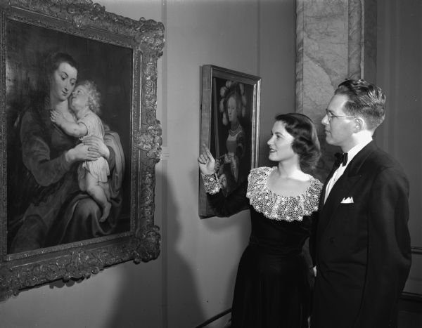 Donald J. and Mary S. Reppen, 717 Knickerbocker Street, are shown admiring the famous painting of "Virgin and Child" by Peter Paul Rubens at the University of Wisconsin Centennial Art Exhibit, held at the Memorial Union. Mr. and Mrs. Reppen were King and Queen of the 1048 Military Ball.