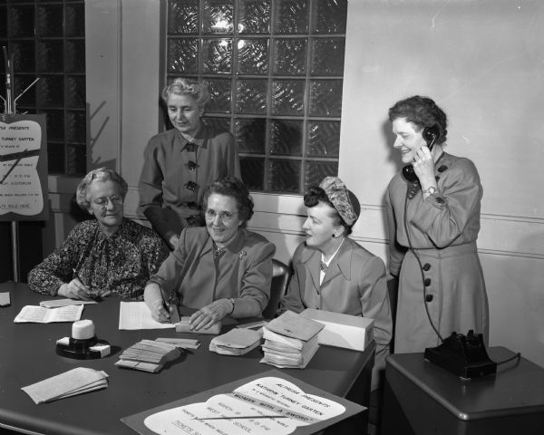 Altrusa Club members preparing for a benefit program for the club's scholarship and hospital fund, at which Kathryn Turney Garten will give a book review. Pictured left to right: Ida Collings, 1010 Mound Street; Lucy Irene Buck, Merrill Springs Road; Mrs. E.J. (Hazel) Kallevang, 4130 Iroquois Drive, club president; Mrs. Rumelia T. Wildeman, 2020 Kendall Avenue, and Alma Wiese, 422 Maple Street.