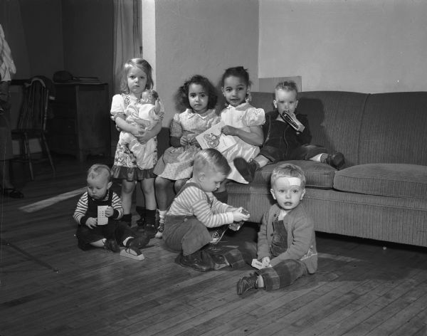 Children at play while their mothers mended clothes for the Quaker relief project on a regular Tuesday session at the home of Mrs. Hilton E. (Lillian) Hanna at 39 North Randall Avenue. From left to right, front row are: Billy Johnson, Gordon Smith and Francis Ackerman; second row: Sandra Zalesky, Mary Hanna, Muriel Simms, and Timmie Johnson.