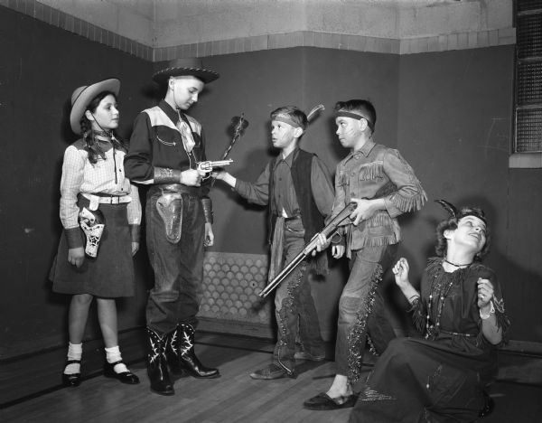 Members of Ethlyn Jefferds' dancing class, fifth and sixth grade students from Shorewood, Randall, and Lakewood schools, attending their first costume ball. Right to left: Jennifer Hill and Hugh Porter, dressed as cowgirl and cowboy; Rose McCanse, Ted Nesvig and Ranyette Schwayn, dressed as Native Americans.