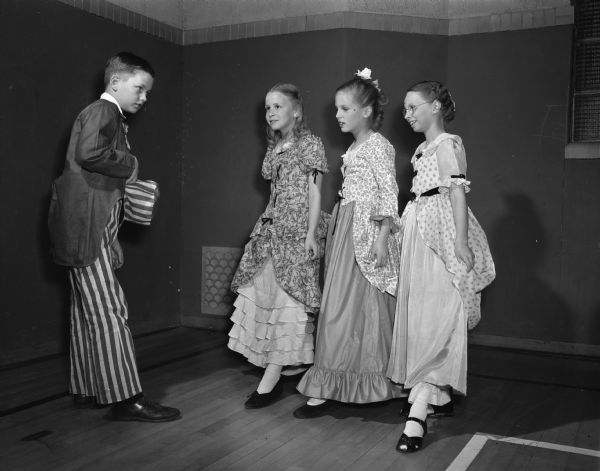 Members of Ethlyn Jefferds' dancing class, fifth and sixth grade students from Shorewood, Randall, and Lakewood schools, attending their first costume ball. Left to right: Ronald Duhr, dressed as Uncle Sam, with Marily McMurray, Dagny Quisling, and Patsy Roe, in colonial dress costumes.
