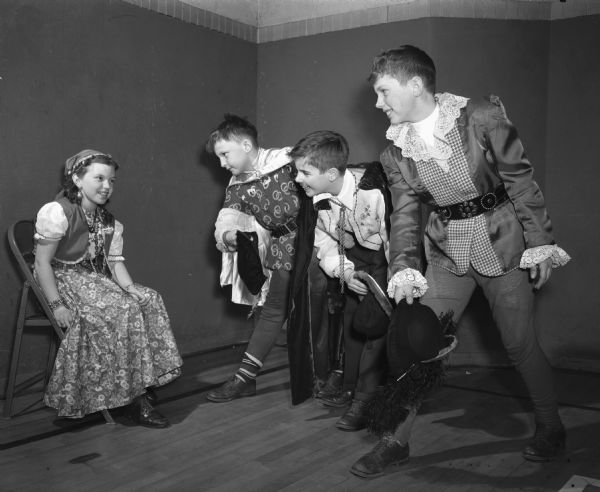 Members of Ethlyn Jefferds' dancing class, fifth and sixth grade students from Shorewood, Randall, and Lakewood schools, attending their first costume ball. Left to right: Marian Clark, dressed as a gypsy: and three "cavaliers," Stephen Kreunen, John Emlen, and Richard Rewey.