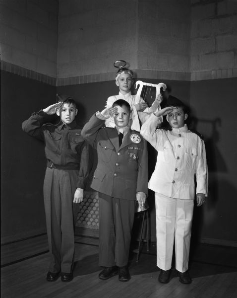 Members of Ethlyn Jefferds' dancing class, fifth and sixth grade students from Shorewood, Randall, and Lakewood schools, attending their first costume ball. Left to right: Kim Curtis in a sailor costume; Keith McCany, dressed as a soldier; David Dudley, a sailor; and behind, Peter Kienitz as an angel.