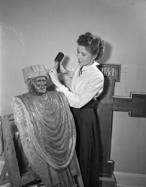 Dorothea Schon, Sun Prairie artist, at work in her studio on her sculpture of Christ the King. When it is completed, the four and a half by three foot wooden sculpture will hang in St. Francis House, the Episcopalian student center at the University of Wisconsin-Madson.