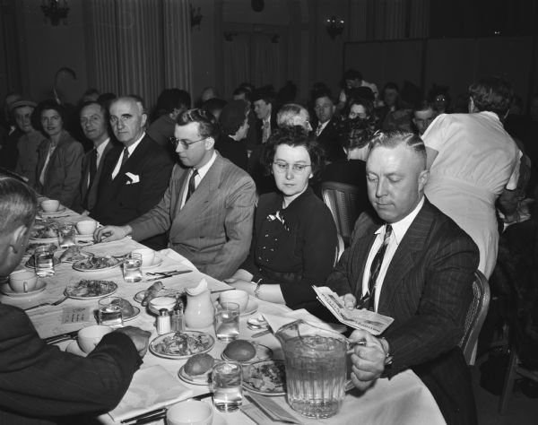 Seated at the speakers table at the Dane County Rural Letter Carriers' meeting (left to right), are: Earl Bagley, Cambridge, treasurer; R.C. Salisbury, Madison, safety director of the state motor vehicle department; Rev. L.A. Benson, assistant pastor of Bethel Lutheran Church, Madison; Mrs. R.A. Woerpel, Marshall, new county auxiliary secretary-treasurer; and R.A. Woerpel, state carriers secretary. A total of 98 mail carriers and their wives attended the annual Washington Day meeting at the Hotel Loraine.