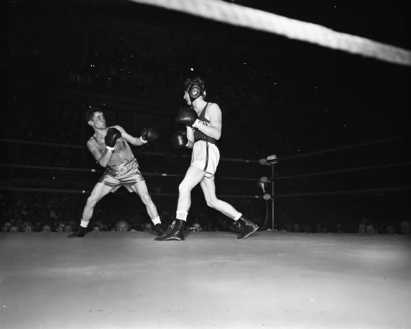 Steve Grembau, right, University of Wisconsin boxer in his match with DeForest Tovey of the University of Idaho.