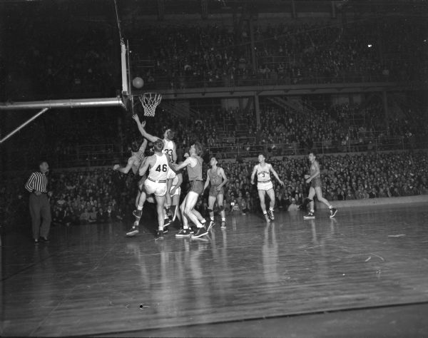 Don Rehfeldt (33), Wisconsin, and Doug Rogers (46), Wisconsin, during the Wisconsin vs. Iowa Western Conference basketball game at the Field House.