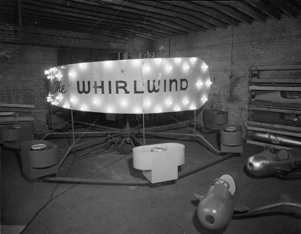 A carnival ride, "The Whirlwind" being constructed in a garage.