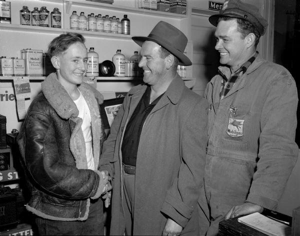 "There are three good reasons for the three beaming smiles shown. Jack Ihde, left, is smiling because he found $176 in cash and $310 in checks, returned the money to its owner, and received a $5 reward. John McCaughey, center, is smiling, because the money Jack Ihde found belonged to him. Grady Noles, right, is smiling because he is the one who lost the money over a week ago."  McCaughey's gas station was at 2132 Atwood Avenue.