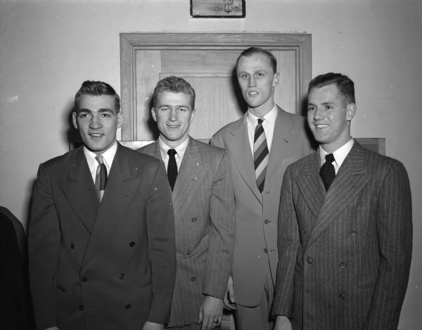 Pictured are four senior members of the 1949 University of Wisconisn basketball team at a banquet at the Park Hotel. Standing from left to right are: Doug Rogers, Bruce Fossum; Robert Haarlow; and Willis Zoro.