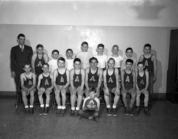 Group portrait of the Frank Allis Grade School basketball team, champions of the Suburban Grade School League. Also pictured, back row left, is Principal-Coach Walter Barr.