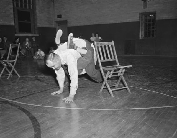 Billy Lorenz and a friend's dad, Howard Wagner, participating in the relay race during Marquette school's family fun night.