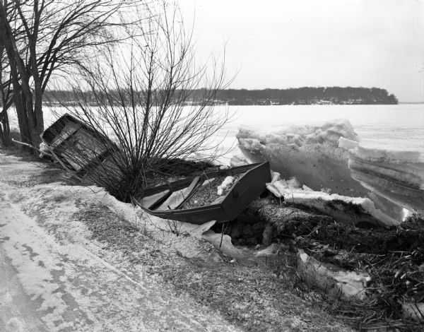 Ice damage to boats along the shoreline of Lake Mendota at Warner Park.