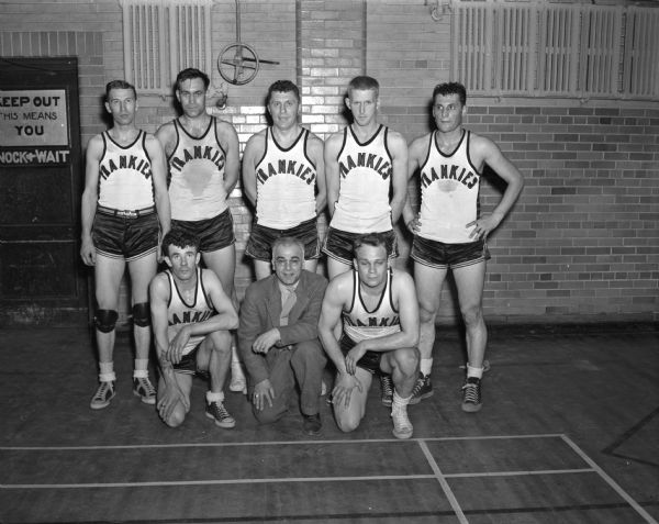 Group portrait of Frankie's Tavern Cagers, winners of the Madison Municipal Basketball tournament. Front row, left to right:  Bob Burns, manager Frankie Lombardo, Paul Vilbrandt.  Back row:  Willard Voss, Les "Pie" Sander, Johnny Kotz, Stan Hill, and Dominic Schiro.