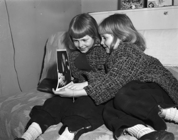 Barbara and Beverly Czyzewski, twin daughters of Mr. and Mrs. Leonard Czyzewski, 166 Monroe park, are shown with a photograph of President Harry S. Truman which they received for their seventh birthday.