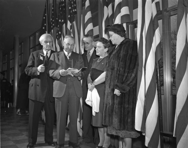 The University of Wisconsin honored the dead of four wars with a concert presented by the University Symphony orchestra and chorus that was attended by some of the parents of soldiers, sailors and marines who gave their lives in the service of their country. Pictured left to right: Professor William Kiekhofer, chair of the University of Wisconsin centennial committee that sponsored the event; Dr. H.H. Morton, Dodgeville, whose son, Donald Morton, died of injuries suffered on a training flight at Gowan field in Idaho; Mr. and Mrs. Walter Jarvis, Richland Center, whose son Lieut. Walter Jarvis Jr. was killed in Japan, and Mrs. Arthur Hays, Portaqe, whose son, Tech. Sgt. Glen Hays, was killed in the Mediterranean area. All the young men mentioned were in the US Air Force.