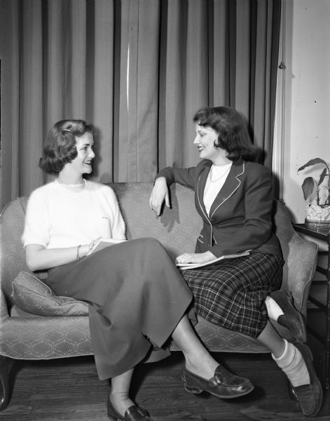 Rosemary Schneiders of Madison at left, and Virginia Rowlands of Minneapolis, Minnesota, at right, members of Kappa Kappa Gamma, two of the six co-eds chosen to serve on the "court of honor" for the UW Military Ball. Members of the court were selected for their attractiveness and charm.