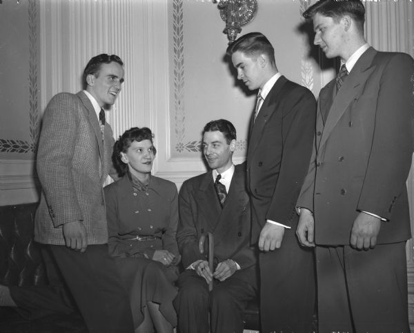 Winners in the American Legion oratorical contest held on the campus of the University of Wisconsin are shown being congratuated by Lieut. Gov. George M. Smith. Left to right: Leo Joyce, fourth place winner; Violet Dortmann, third place; Lieut. Gov. Smith; Kent Herath, second place; and Edmund Kersten, first place.
