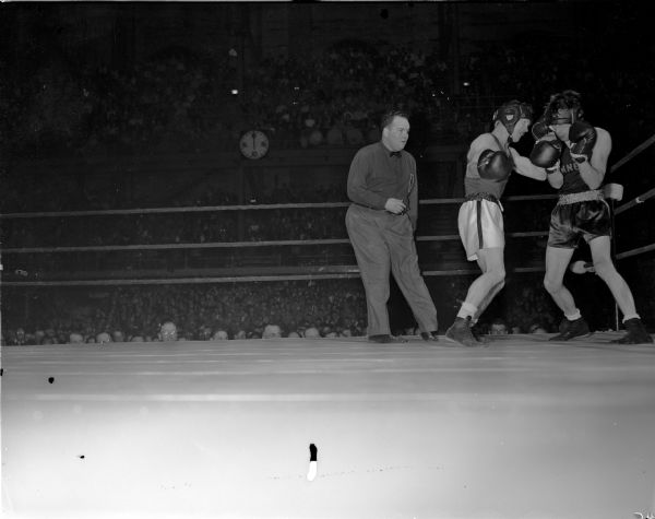 University of Wisconsin boxer James "Red" Sreenan (left) fighting against Harold Brown of the University of Minnesota at the University of Wisconsin-Madison Field House.