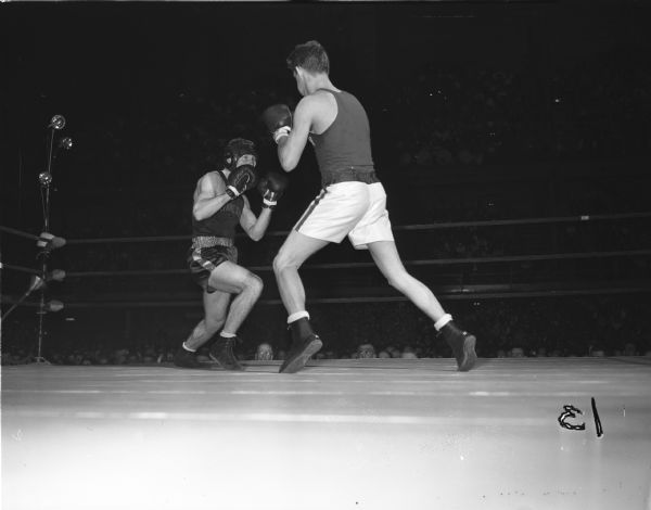 University of Wisconsin boxer John Lendenski (left) spars with Colin Connell of the University of Minnesota in their boxing match at the fieldhouse.