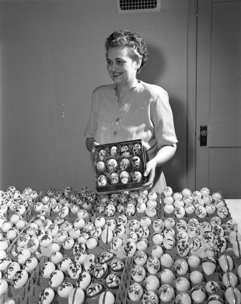 Madison artist Mrs. Russell (Fern) Fowler, 3315 Blackhawk Drive, with a display of her hand-painted china Easter eggs. The eggs were popular during the Victorian age, but fell into disuse until Mrs. Fowler revived the art.