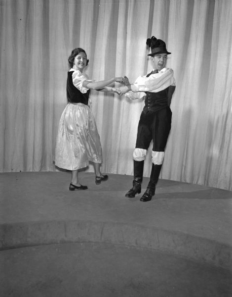 Mary Jane Iss of Milwaukee, a co-ed of Austrian descent and co-chairman of the International Club's social committee, and Edward Bank of Algoma, whose ancestors are Bohemian, dancing a Tyrolean landler at the University of Wisconsin's International Club Ball at the Memorial Union.