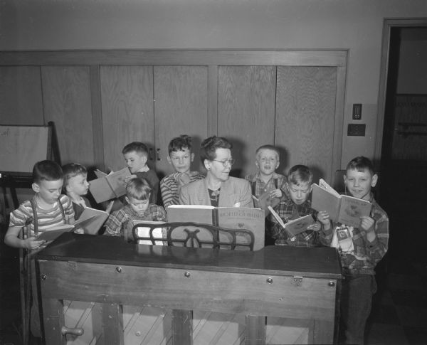Mrs. Georgia Phillips leads boys of the primary classes in group singing at the orthopedic department at Washington School, 545 West Dayton Street.
