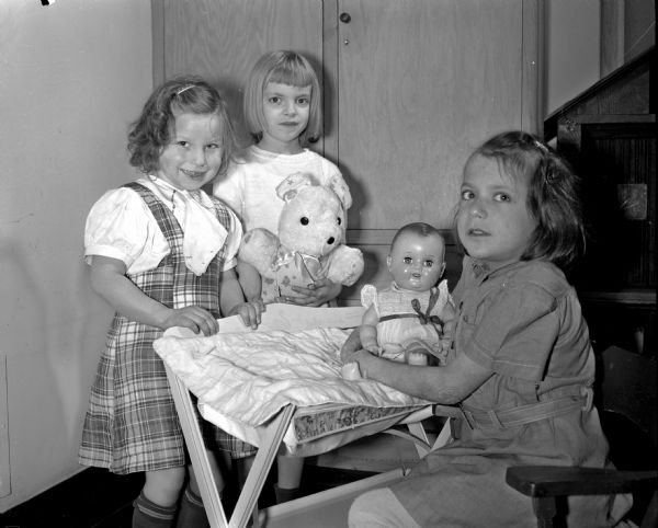 Taking motherly care of their dolls in the orthopedic department at Washington School are, left to right: Jeanne Laugen, Virginia Czerpinski, and Marian McElmurry. Washington School is located at 545 West Dayton Street.