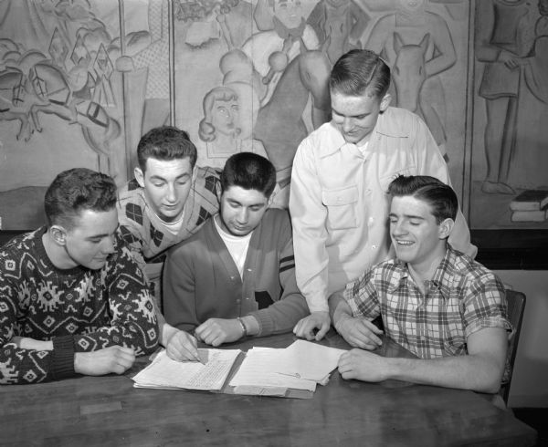 A group of senior students from Central High School plan some of the school's special commencement activities. Left to right: Roger Lewis, Harvin Fruth, George Guzzetta, Walter Northup (standing), and David Schneider. Northrup is president of Central High's senior class.