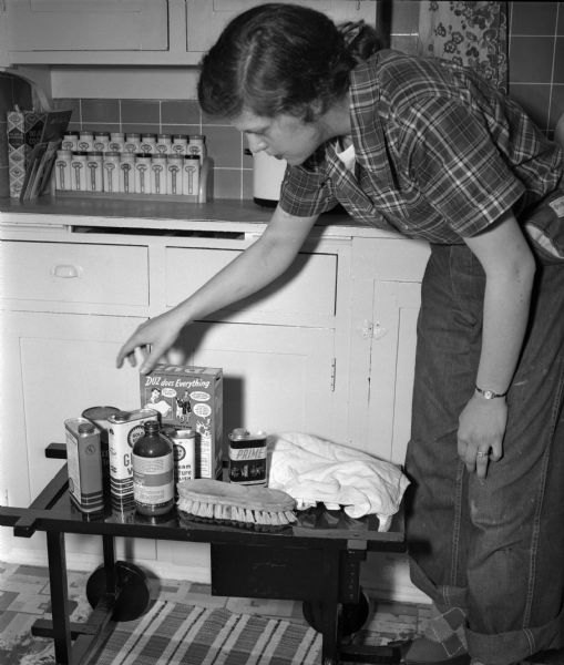 Mrs. William B. (Rachel) Fisher, 733 Copeland Avenue, assembling the cleaning products she will use during spring house cleaning. A new bride, this is her first spring cleaning.