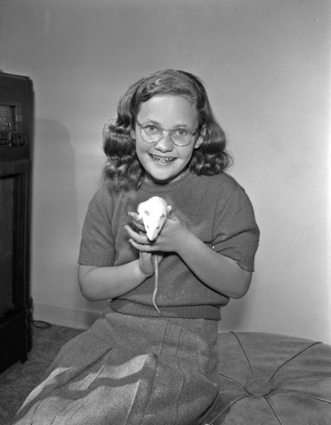 Sharon Koepke, twelve-year-old daughter of Mr. and Mrs. Philip (Joy) Koepke, 830 Hiawatha Drive, with her pet white rat, "Bonnie".