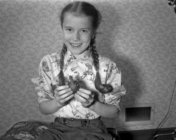 Nine-year-old Susan Kamm, daughter of Mr. and Mrs. Kermit (Marjorie) Kamm, 1015 Yale Road, is pictured with her pet turtle, "Barney". Susan purchased her pet turtle at a circus two years ago, and named him in honor of P.T. Barnum.