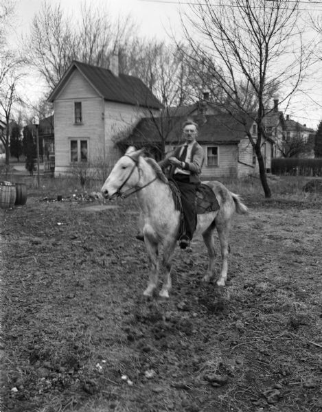 Stoughton resident, Edward McCarthy, mounted on his horse "Hi Ho Silver." He brought his horse with him when he moved into the city from outside the city limits, but when neighbors complained city officials told McCarthy he had to remove the horse for violating a city ordinance.