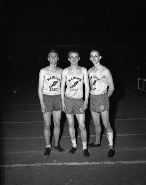 Gary Hall, Leo Shillinglaw and Bob Cnare, Class A 180-yard high hurdle shuttle relay team, won their event in the University Field House with a 22.8 second record. Hall had a knee injury that bothered him considerably but did not prevent a win for the team.