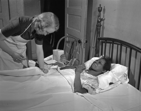 Visiting nurse Esther Sorensen changes a wound dressing for patient Connie Taylor who is blind and recovering from a fall.