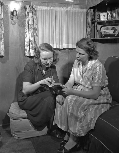 Visiting nurse Esther Sorensen giving some advice about pre-natal problems to Mrs. Arnold Davis, a wife of a GI student at the University of Wisconsin.