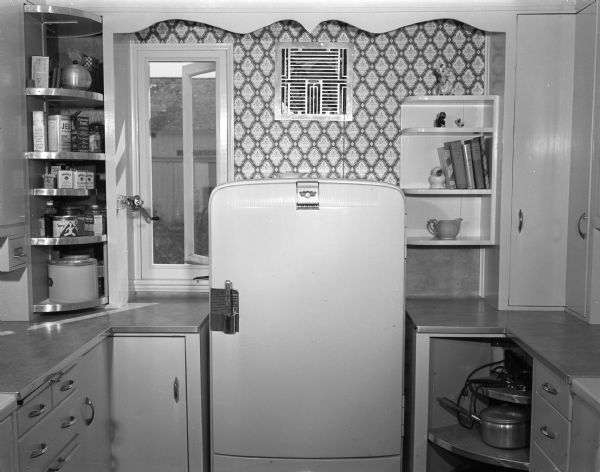 Remodeled kitchen in the home of Mr. and Mrs. Walter Renk, Route 2, Sun Prairie showing the four rotating corner cupboards next to the refrigerator.