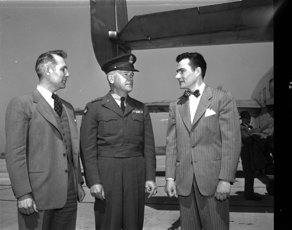 General J. Lawton Collins, Vice-Chief of Staff of the U.S. Army, center, is met at Truax Field by Charles Isenberger, at right.
The general was the speaker at the annual Gridiron Banquet. Mr. Isenberger was president of Sigma Delta Chi, a professional journalism fraternity, sponsor of the event. The man at left is unidentified.