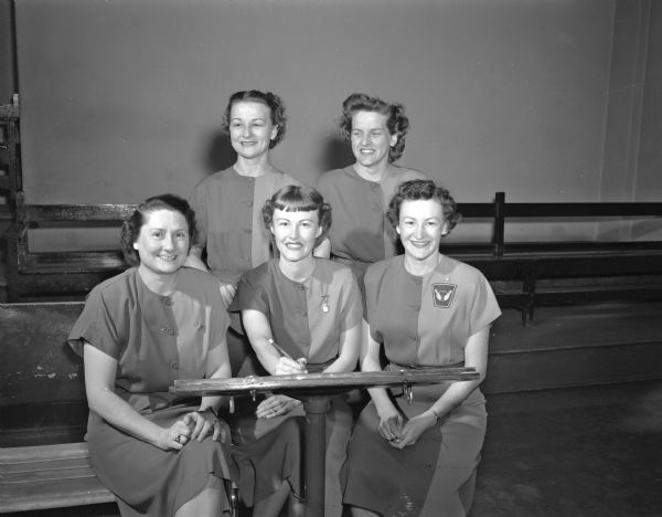 Group portrait of six members of the WIBC 600 Club Women's bowling team taken at a bowling alley.