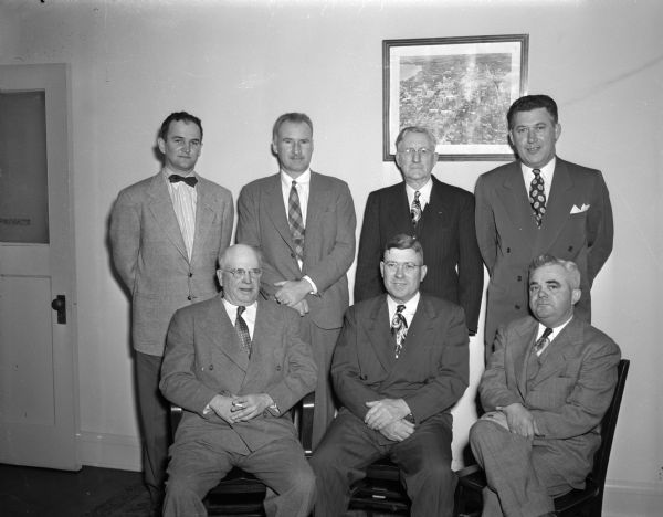 Group portrait of the members of the new Madison City Council. Front row, left to right: Ray Fessenden, John E. Coyne, and Frank Haas. Back row: Willilam C. Sachtjen, George Hall, Harrison L. Garner, and Ted. C. Boyle.